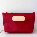 Red pouch with a beige patch on a white background