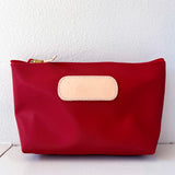 Red pouch with a beige patch on a white background