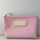 Pink pouch with a beige patch on a white background