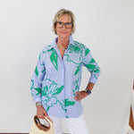 Woman wearing a floral shirt with a white background