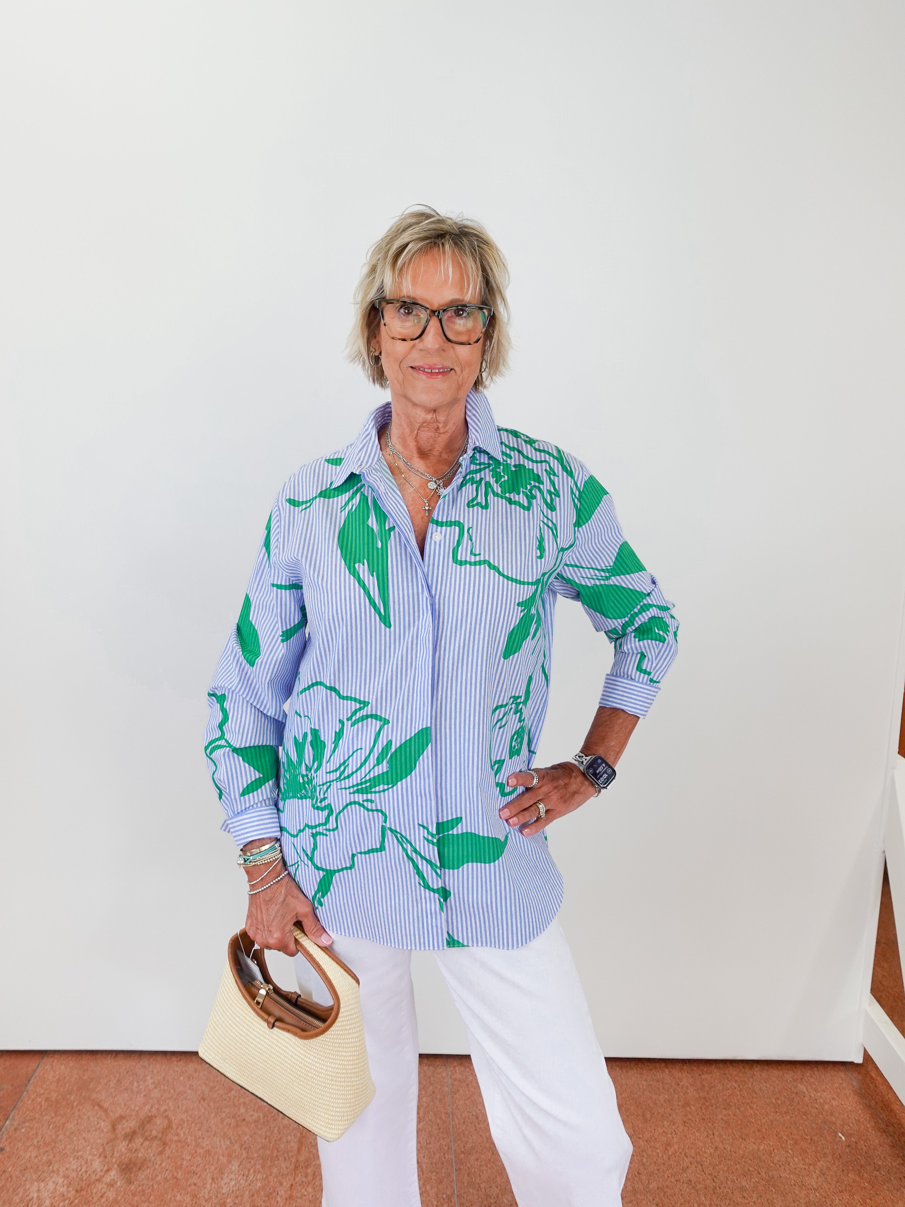 Woman wearing a floral shirt with a white background