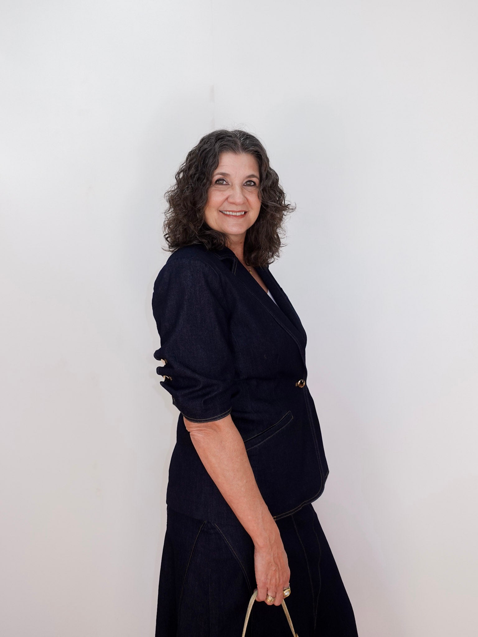 Woman wearing a black outfit against a white background