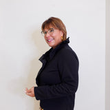 Woman wearing a black coat against a white background