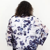 Person wearing a patterned jacket on a white background