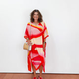 Woman wearing a colorful dress with a white background