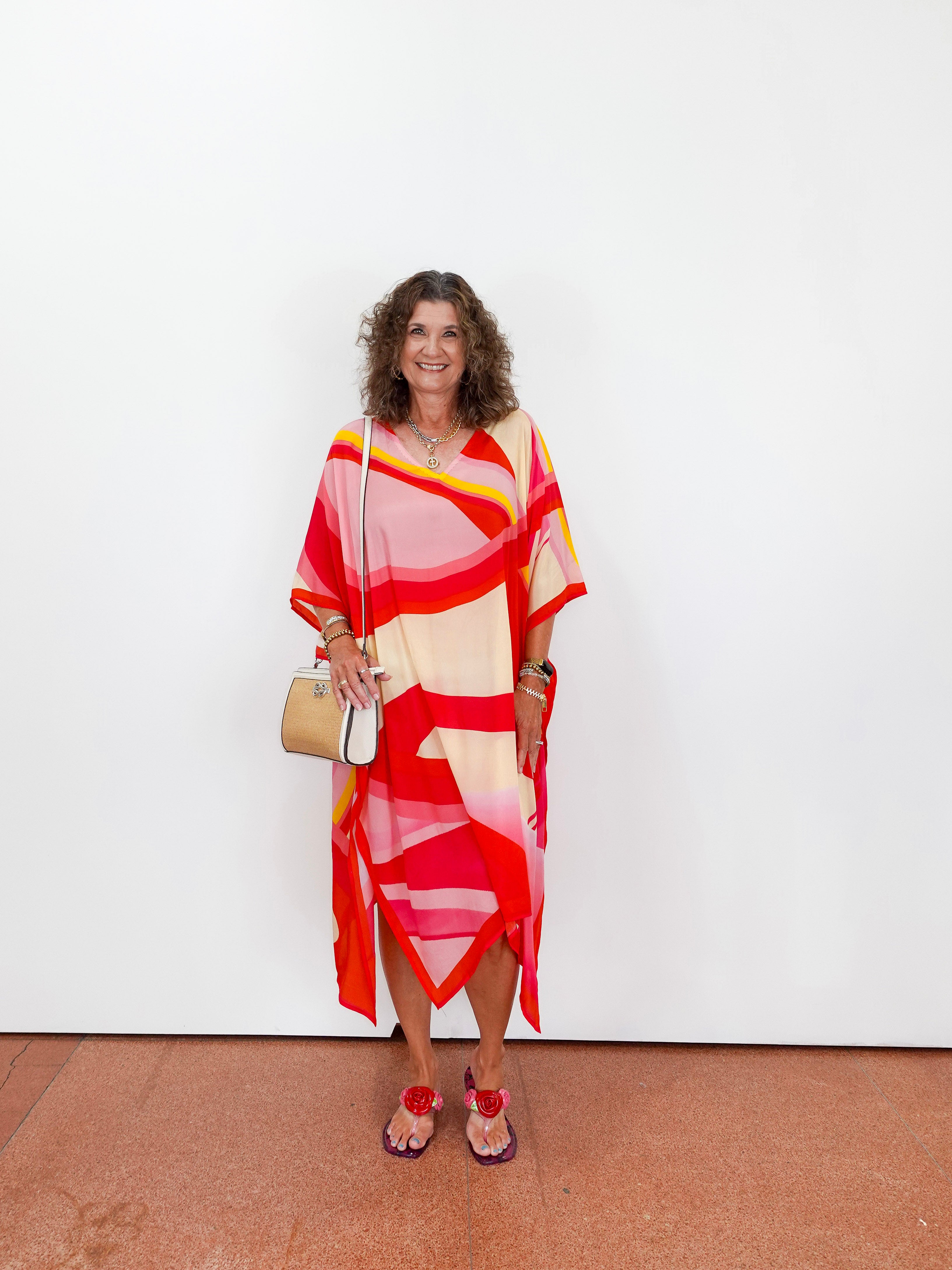 Woman wearing a colorful dress with a white background