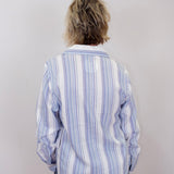 karen kane long sleeve lace up top featuring a striped pattern and lace up neckline worn by model