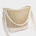 Woven handbag with beige strap on a white background