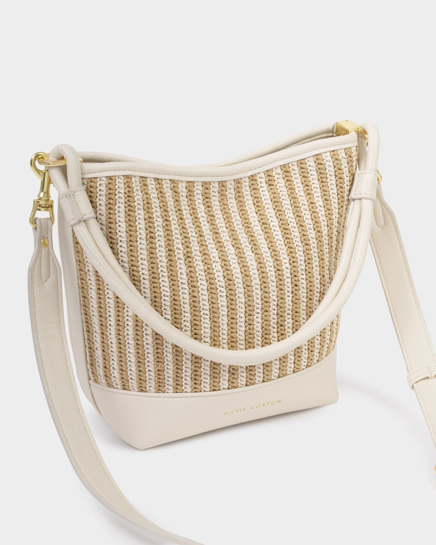 Woven handbag with beige strap on a white background
