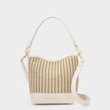 Woven handbag with beige strap on a white background