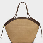 Beige handbag with brown leather accents on a light gray background