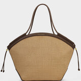 Beige handbag with brown leather accents on a light gray background