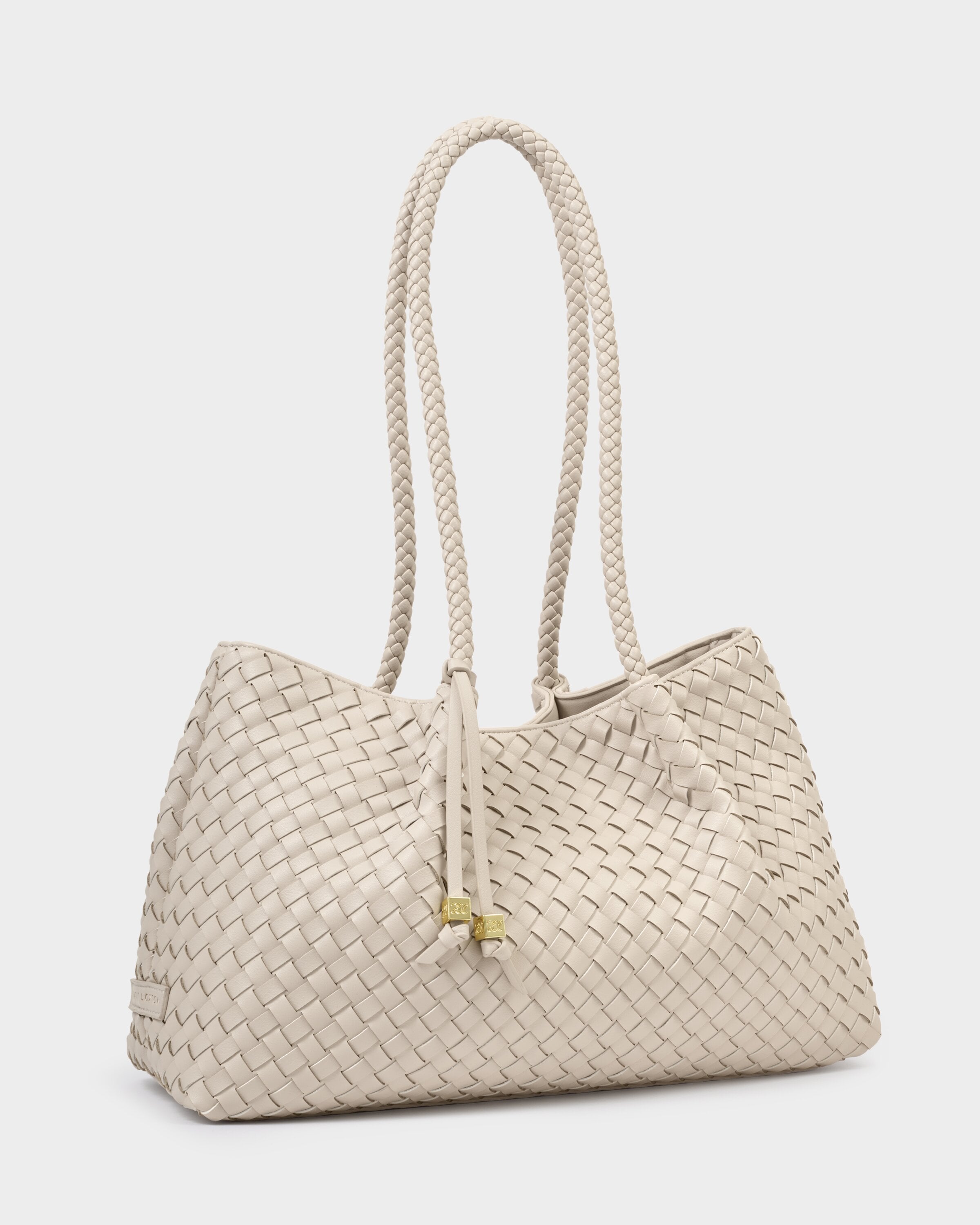 Beige woven handbag with a rope handle on a light gray background