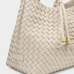 Beige woven handbag with a visible brand logo on a light gray background