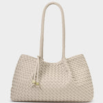 Beige woven handbag with rope handle on a white background