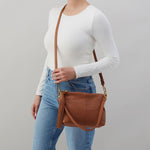 Hobo Kori Crossbody in warm honey leather with adjustable strap and zip closure