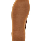 Brown sole of a shoe with a textured surface on a white background