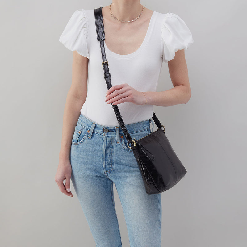a black hobo medium crossbody against a white background. 