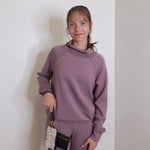 woman modeling the Hobo black phone wristlet 