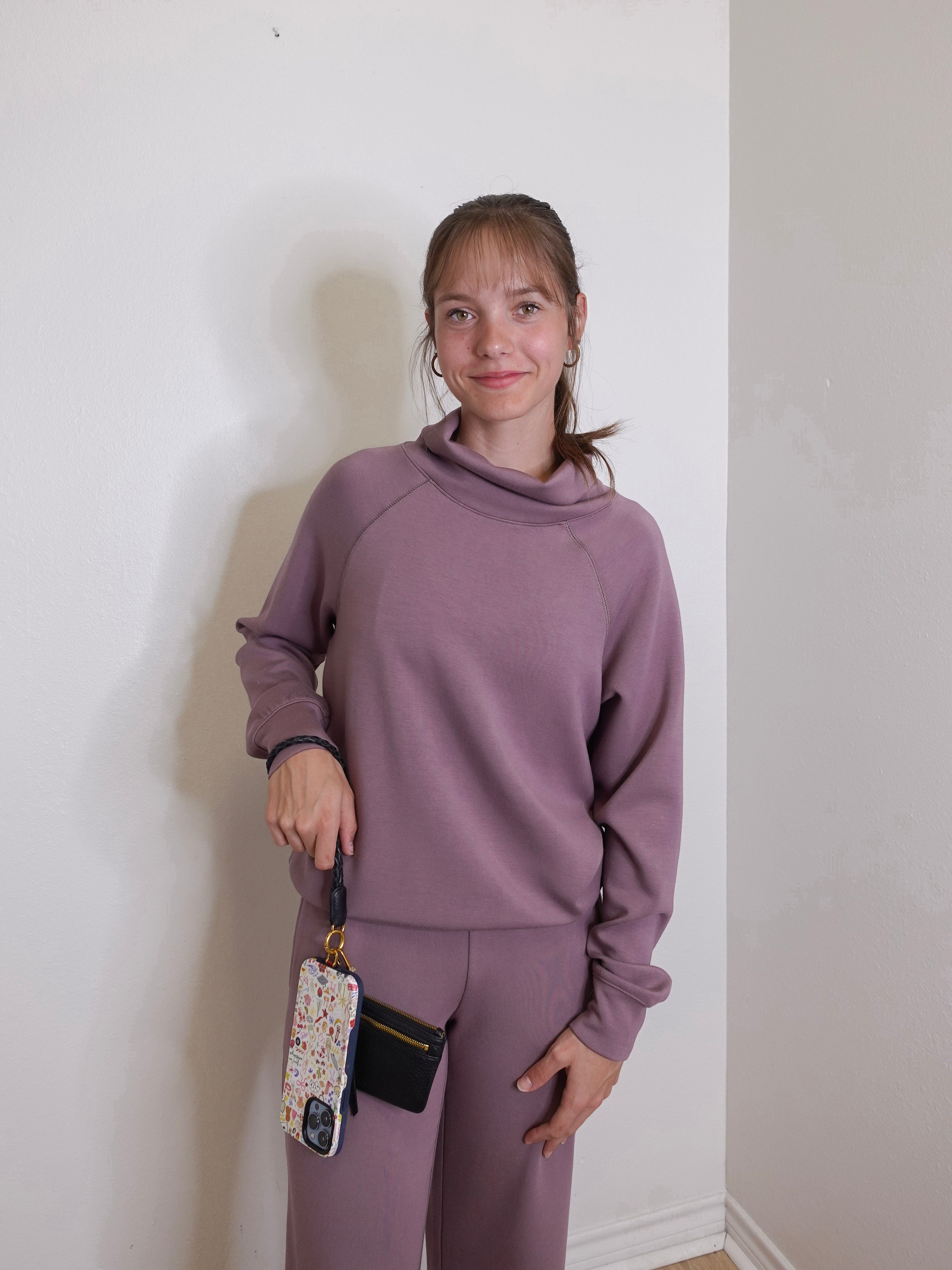 woman modeling the Hobo black phone wristlet 