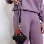 woman modeling the Hobo black phone wristlet 