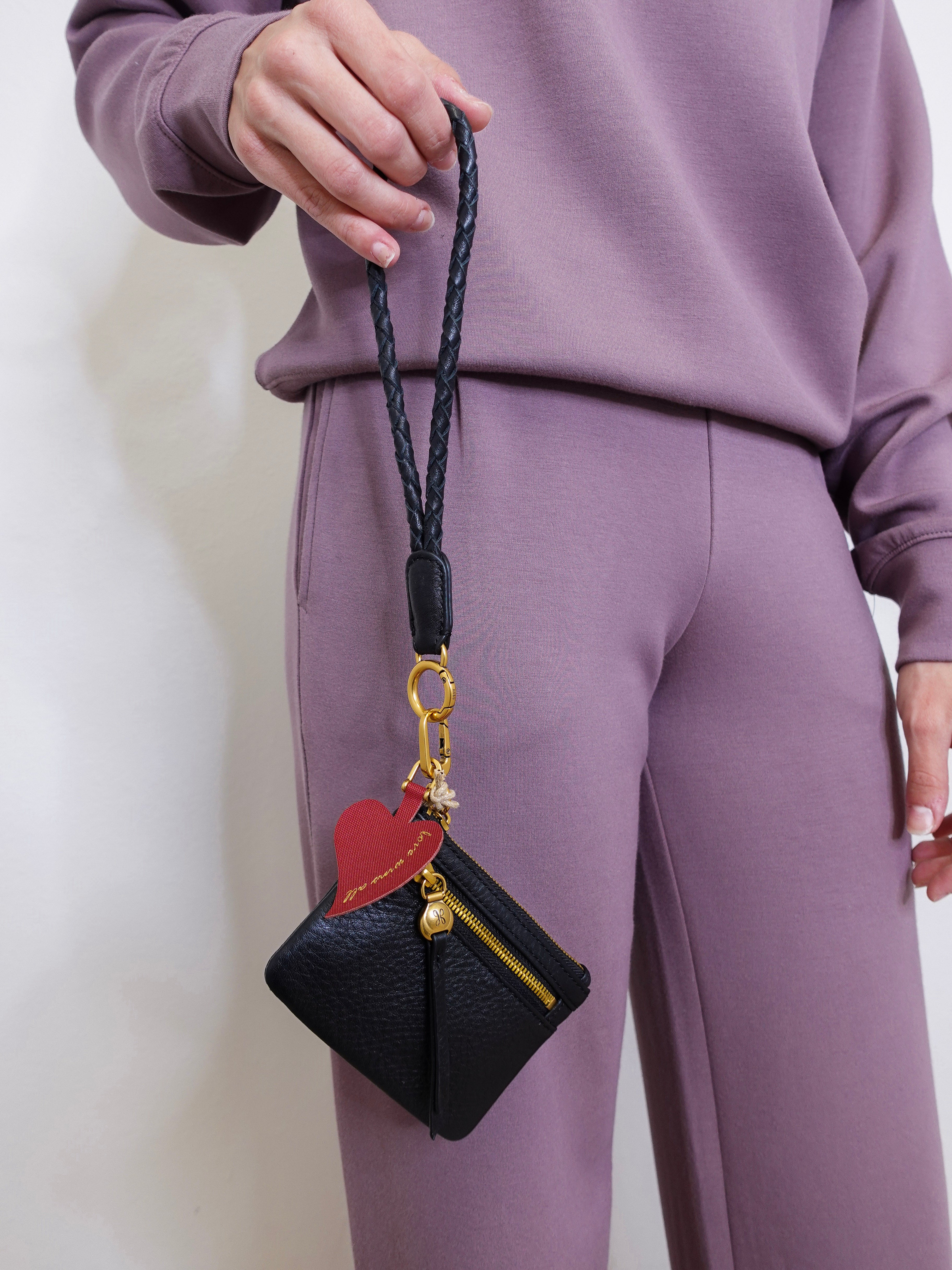 woman modeling the Hobo black phone wristlet 