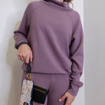 woman modeling the Hobo black phone wristlet 