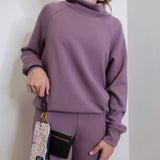 woman modeling the Hobo black phone wristlet 