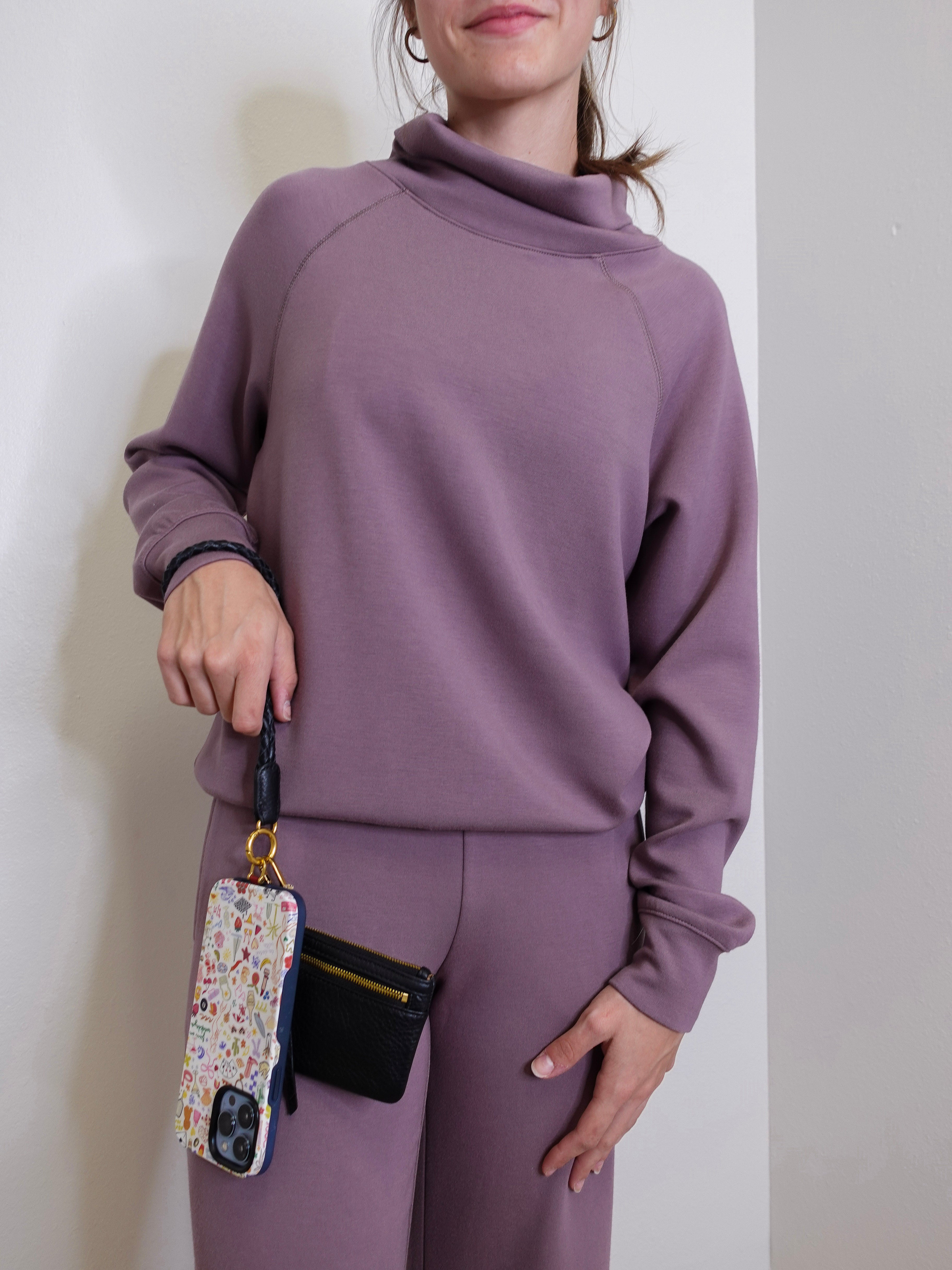 woman modeling the Hobo black phone wristlet 