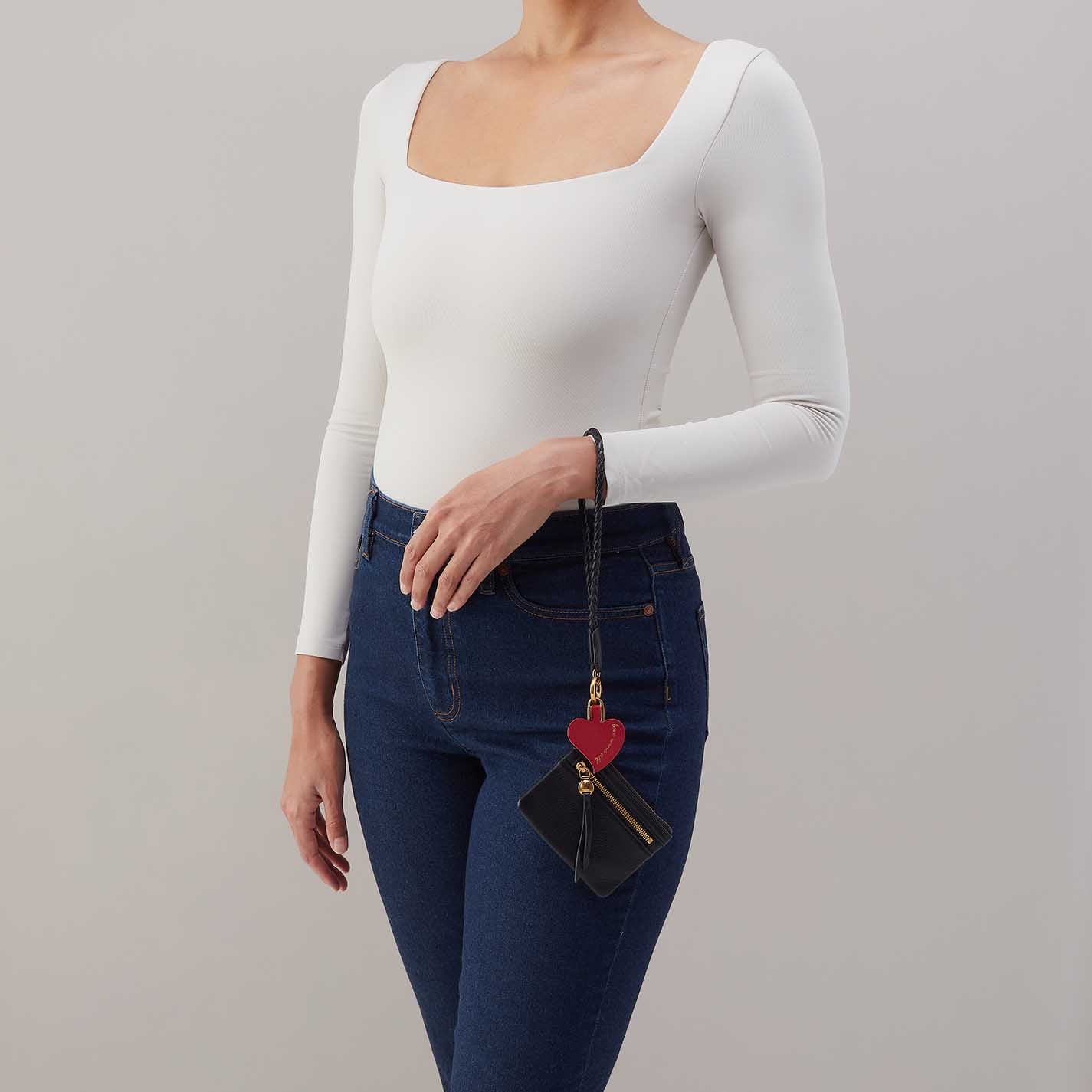 Woman wearing a lasso phone wristlet on her wrist 