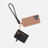 black lasso phone wristlet with phone attached on a white background. 