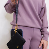woman modeling the Hobo black phone wristlet 