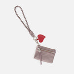 Hobo lasso phone wristlet in metallic leather, color pewter spur against a white background. 