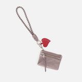 Hobo lasso phone wristlet in metallic leather, color pewter spur against a white background. 