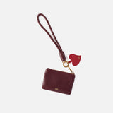 lasso phone wristlet in pebbled leather mulberry glaze color against a white background. 