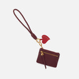 lasso phone wristlet in pebbled leather mulberry glaze color against a white background. 