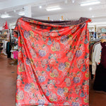 Floral patterned fabric draped over a person in a store setting