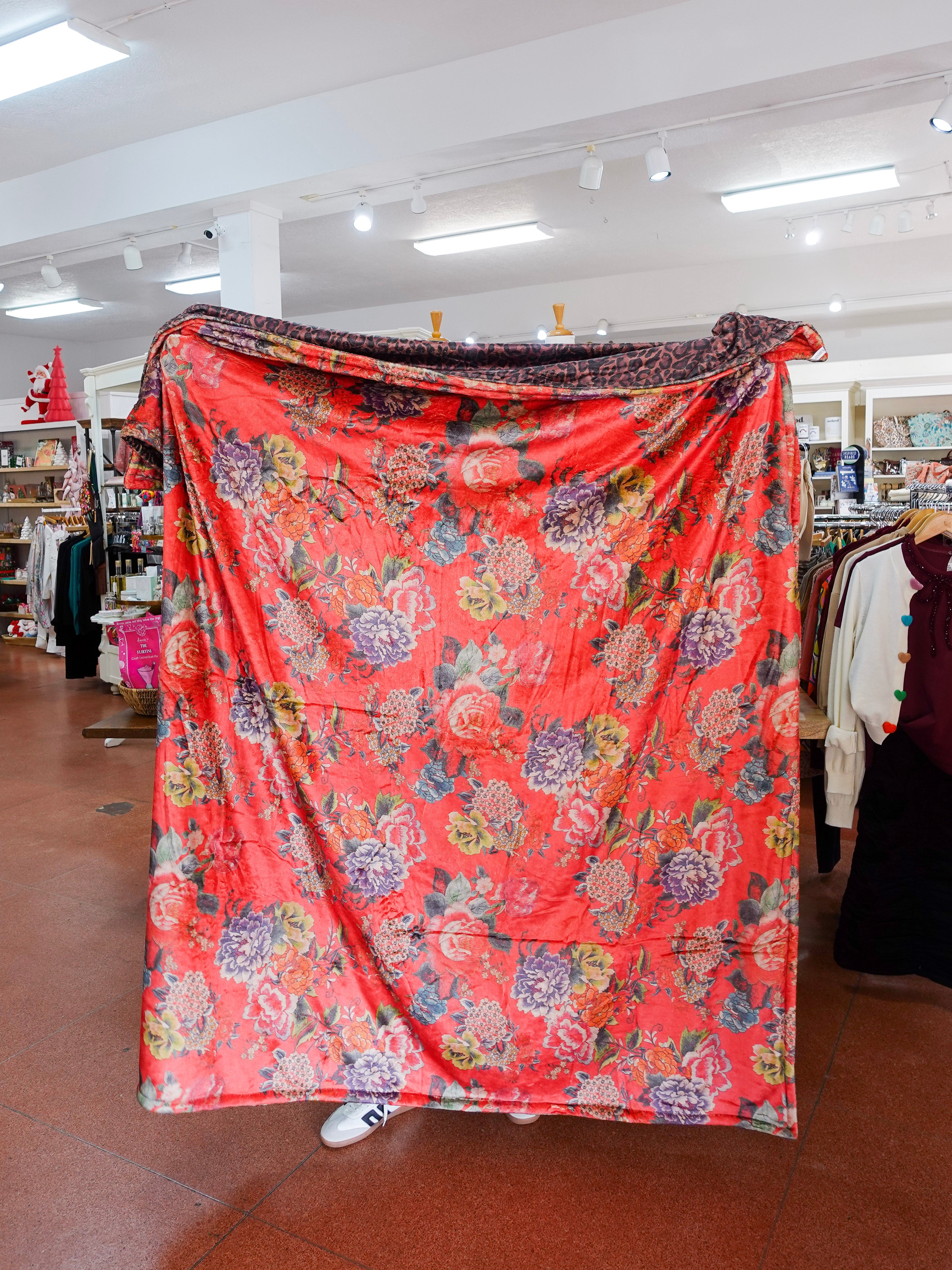 Floral patterned fabric draped over a person in a store setting