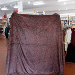 Patterned fabric draped over a mannequin in a store setting