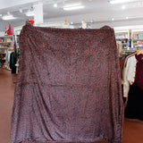 Patterned fabric draped over a mannequin in a store setting