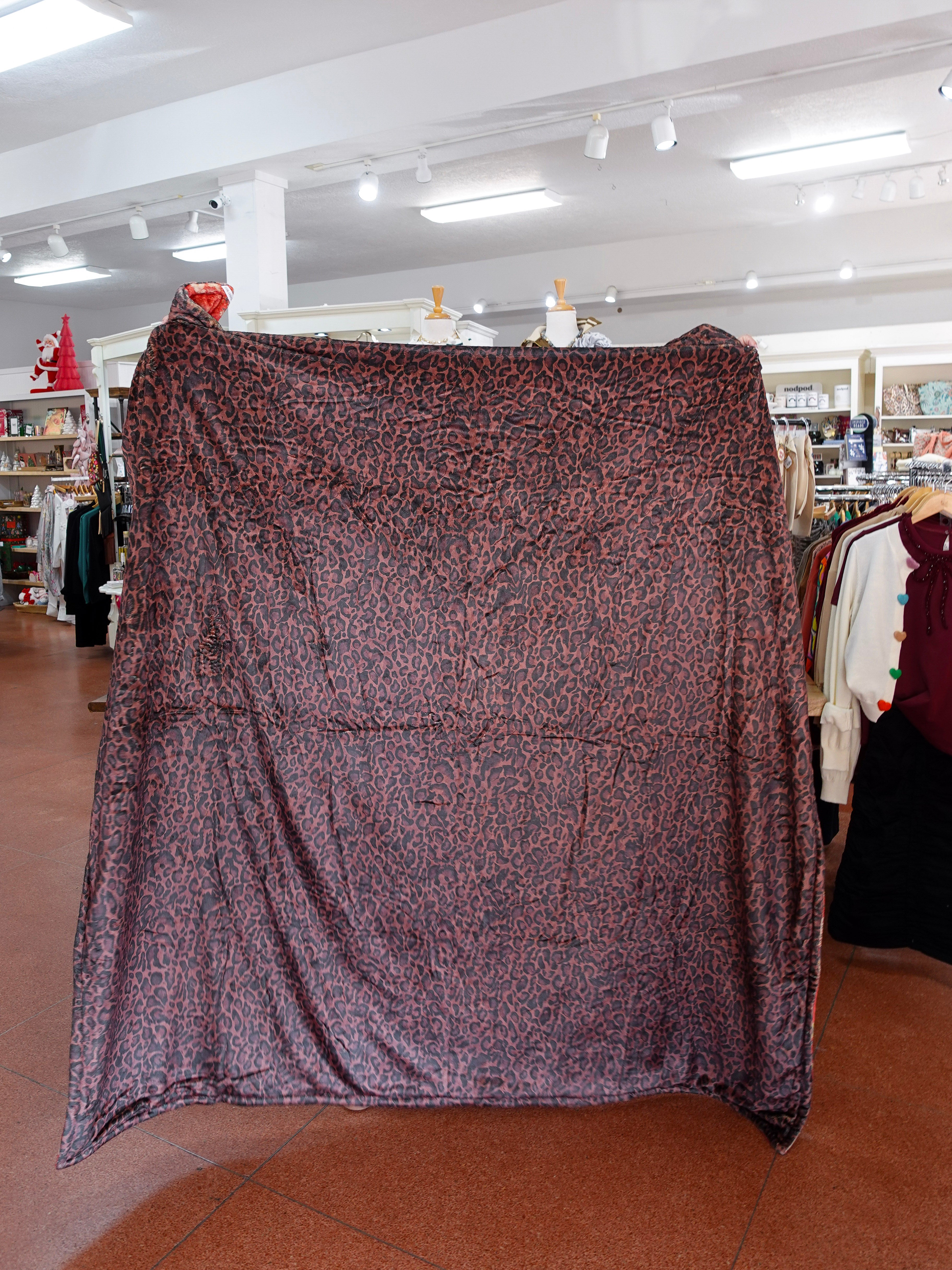 Patterned fabric draped over a mannequin in a store setting