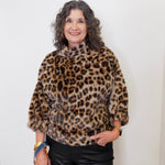 Woman wearing a leopard print sweater against a white background