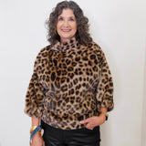Woman wearing a leopard print sweater against a white background