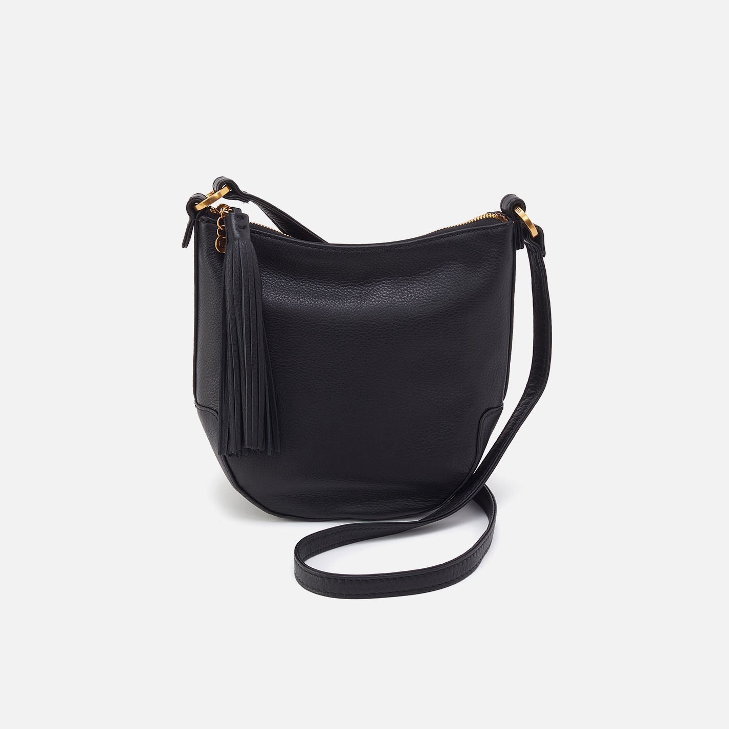 Black leather handbag with a strap on a light gray background