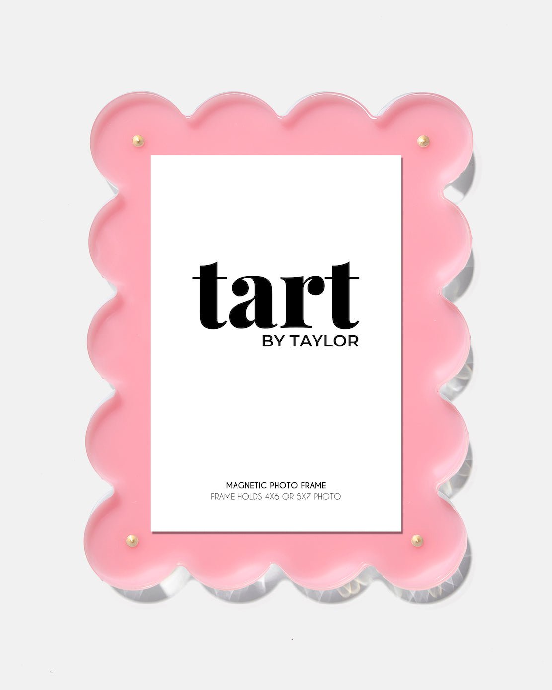 Pink scalloped photo frame with 'tart by Taylor' branding on a white background