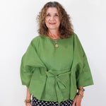 Woman wearing a green top with a white background