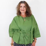 Woman wearing a green top with a white background