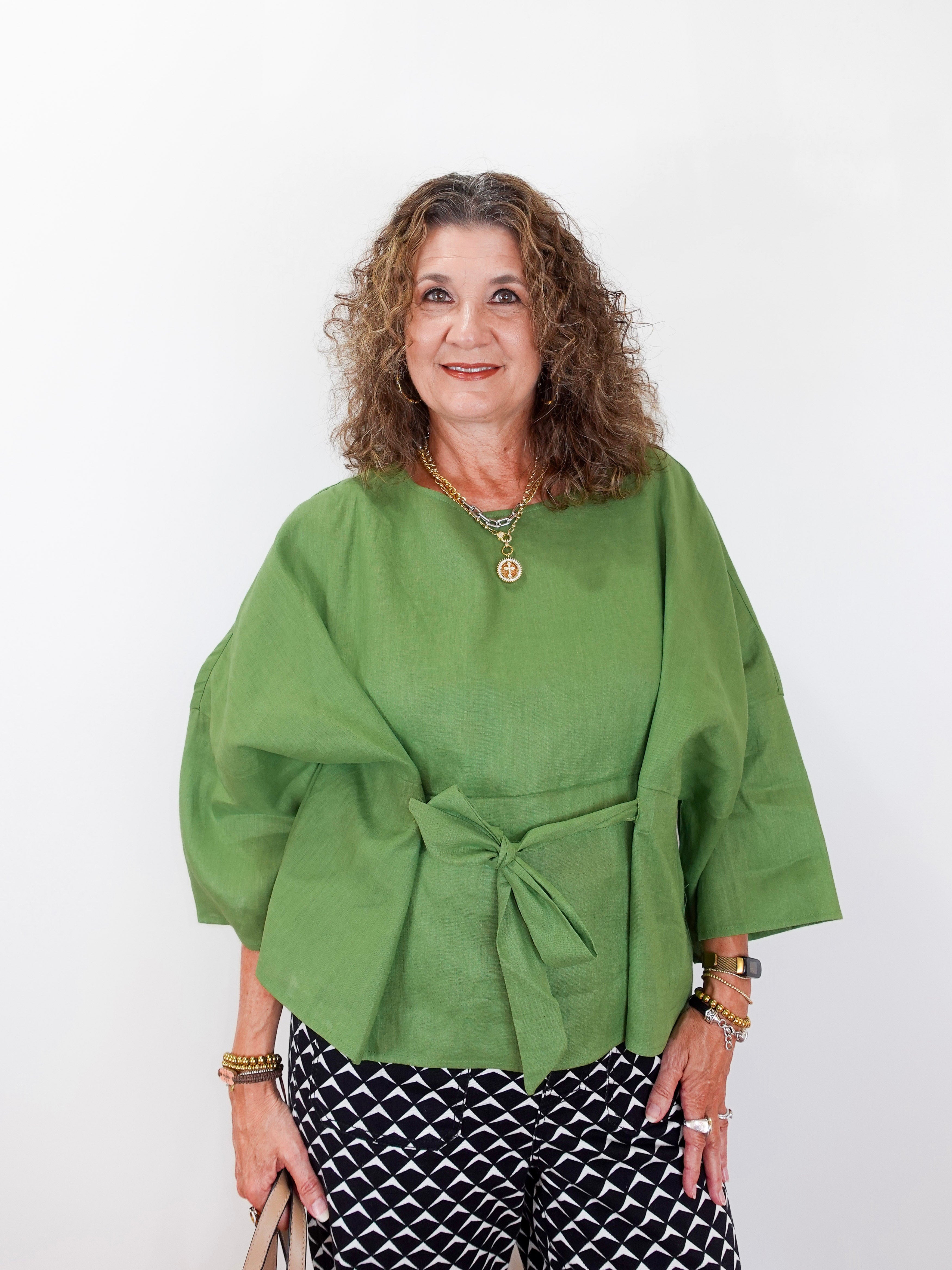 Woman wearing a green top with a white background