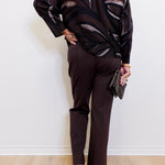 woman wearing the  brown Ponte kick flare pant against a white background. 