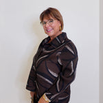 woman wearing a liv chocolate brown Parisian pleated blouse. 